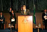 Harry Jenkins at the podium in the Great Hall of Parliament House, with Jenny Macklin, Kevin Rudd and Malcolm Turnbull in the background.