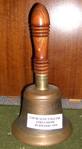 Bell with a tag on it saying 'CHURCH OF ENGLAND GIRLS HOME BURWOOD NSW'
