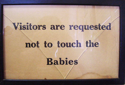Sign saying 'Visitors are requested not to touch the babies'